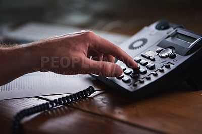 Buy stock photo Shot of an unidentifiable businessman using a desk phone in the office