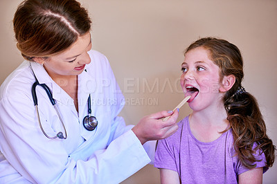Buy stock photo Shot of a pediatrician examining a little girl in her office