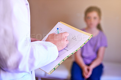 Buy stock photo Shot of a pediatrician examining a little girl in her office