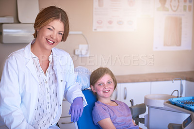 Buy stock photo Shot of a female dentist attending to her young patient