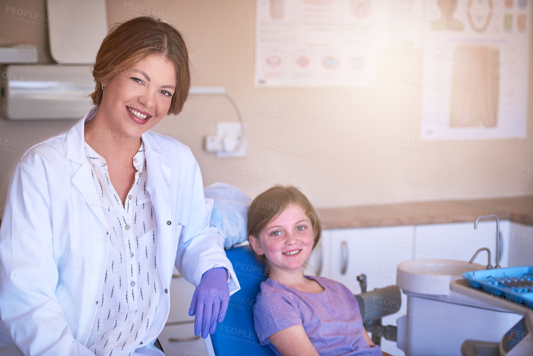 Buy stock photo Shot of a female dentist attending to her young patient
