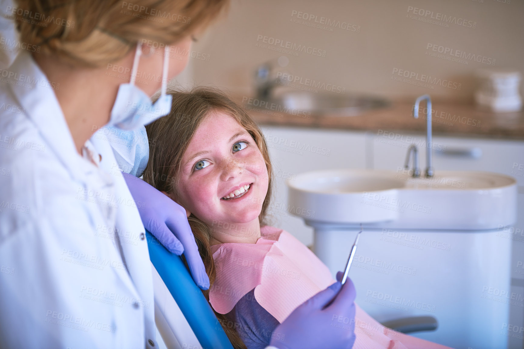 Buy stock photo Smile, girl and dentist with dental checking with oral hygiene and teeth care with patient and mouth exam. Toothache, cleaning and medical help with kid doctor and dentistry tool for healthcare
