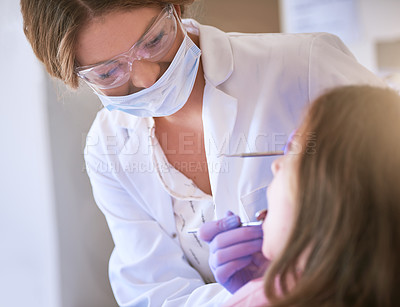 Buy stock photo Cropped shot of a dentist examining a little girl's teeth