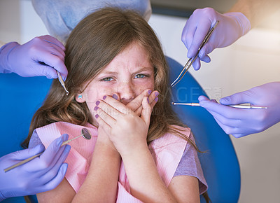 Buy stock photo Shot of a little girl looking terrified as dentists get ready to examine her