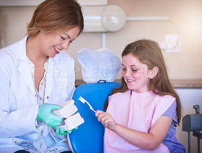 Buy stock photo Dentist, advice and child with teeth for learning, consultation appointment or checkup with smile. Model, doctor and happy kid with toothbrush hygiene for teaching, help or dental care with woman