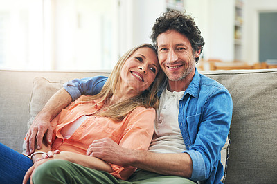 Buy stock photo Portrait of a happy mature couple relaxing together on the sofa at home