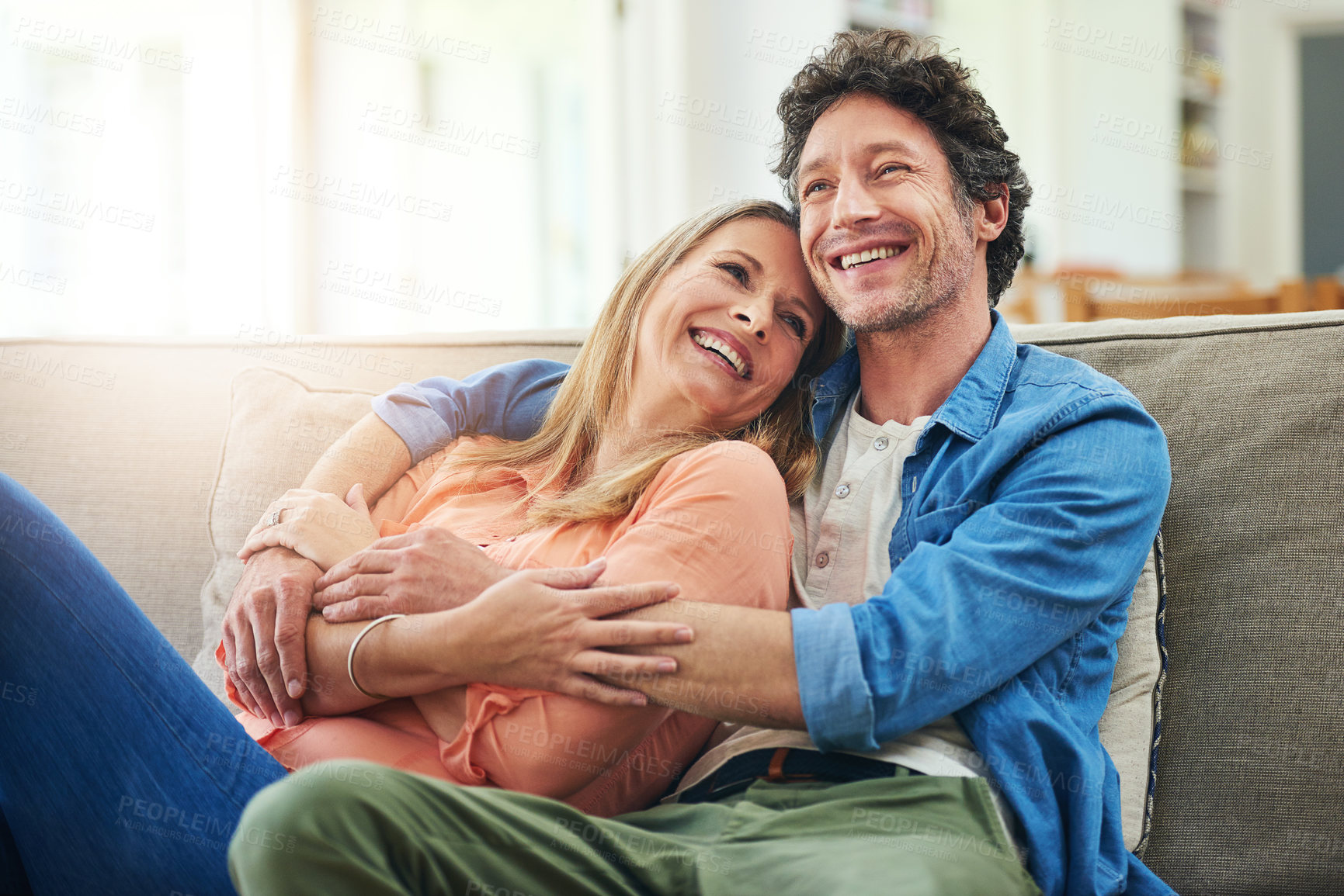 Buy stock photo Shot of a happy mature couple relaxing together on the sofa at home