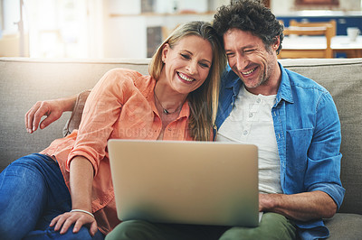 Buy stock photo Couple, laptop and couch in home, happy and relax for choice with movie, show or streaming subscription. Mature people, man and woman with computer on sofa in living room with embrace, film and smile