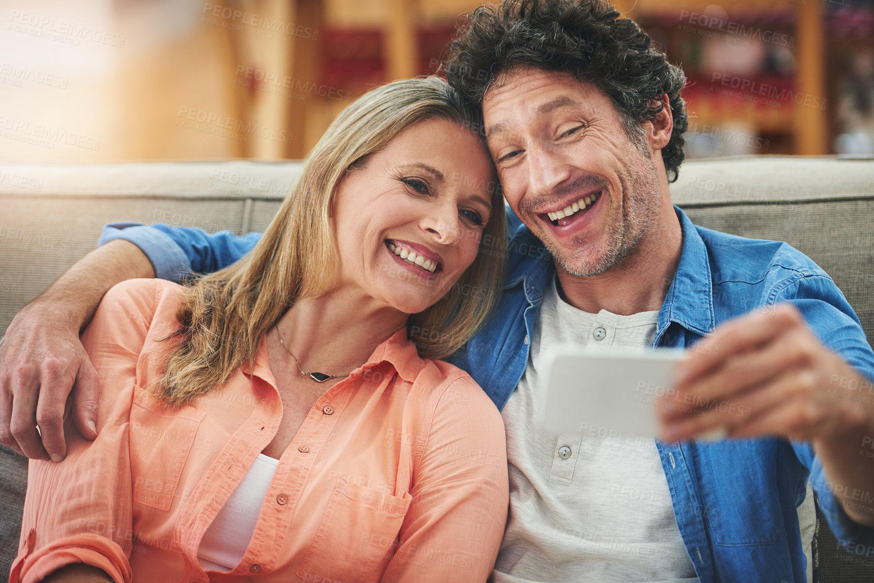 Buy stock photo Couple, selfie and sofa in home, smile and excited for memory with bonding for love with connection. People, man and woman with embrace for care, happy and profile picture on app for social network