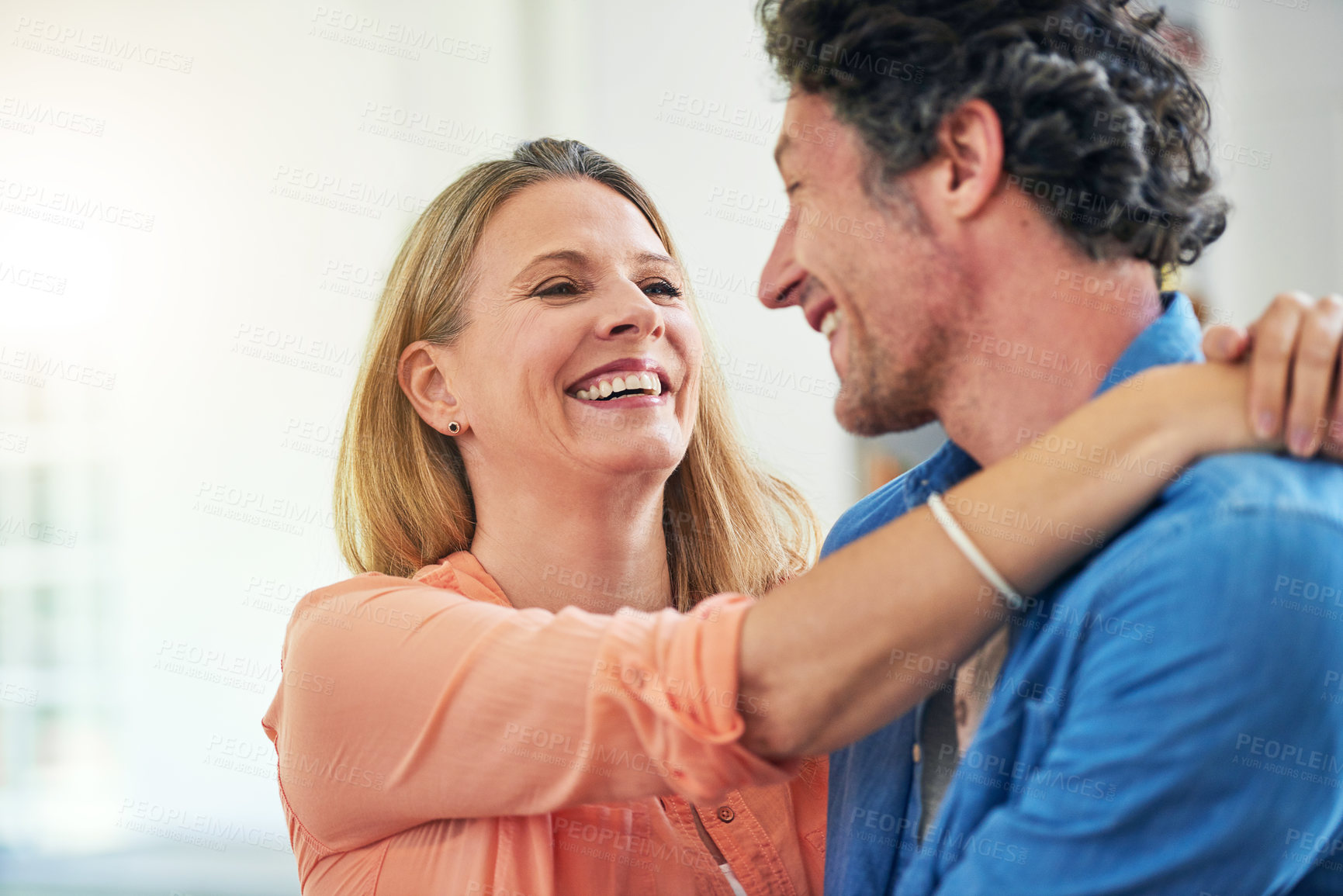 Buy stock photo Happy couple, embrace and hug in home with love, marriage and romance for man and woman in living room. Laugh, smile or support or solidarity for relationship, relax or trust for commitment and joy