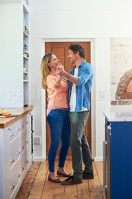 Buy stock photo Shot of a happy mature couple dancing together at home