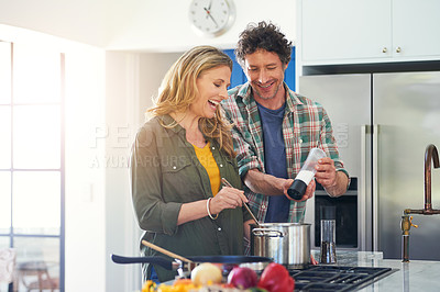 Buy stock photo Love, salt and flavor with a couple cooking in the kitchen of their home together for health, diet or nutrition. Smile, food or recipe with a happy mature man and woman in their house for seasoning