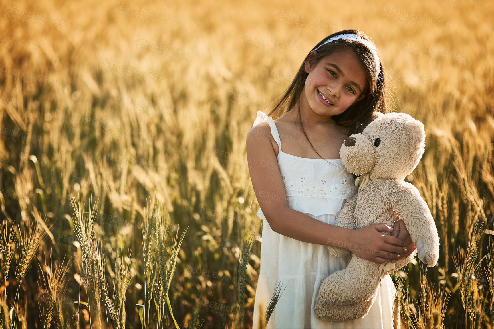 Buy stock photo Outdoor portrait, smile and girl with teddy bear for development, play and childhood in cornfield. Young child, happy and toy animal for bonding with healthy growth, space and calm weekend in nature