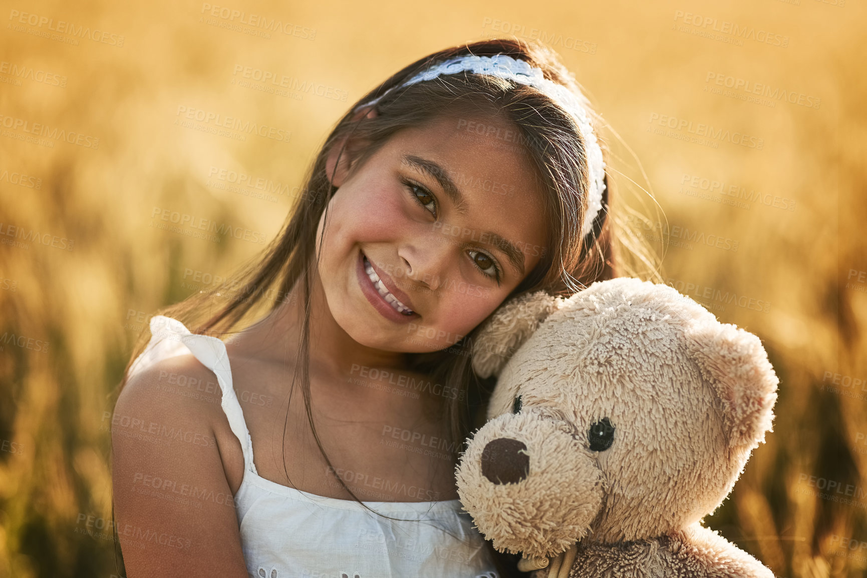 Buy stock photo Outdoor portrait, happy and girl with teddy bear for development, play and mockup in cornfield. Young child, smile and toy animal for bonding with healthy growth, space and calm weekend in nature