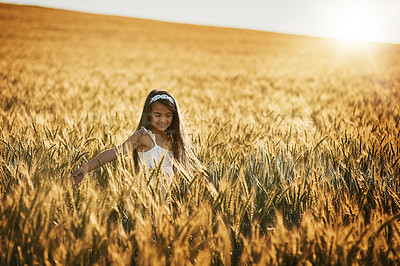 Buy stock photo Girl, happy and play in corn field for adventure, games and environment or outdoor in summer. Child, smile and open arms for freedom, peace and development in countryside for vacation and holiday 