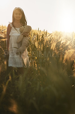 Buy stock photo Happy, girl and teddy bear with portrait in nature for love, care and hug in field or countryside. Child, embrace and toy for play in environment for holiday, growth and development or outdoor game