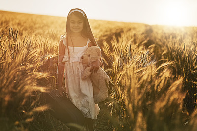 Buy stock photo Girl, portrait and teddy bear in nature for love, care and hug in corn field or countryside. Kid or child, embrace and toy for play in environment for holiday, growth and development or outdoor game