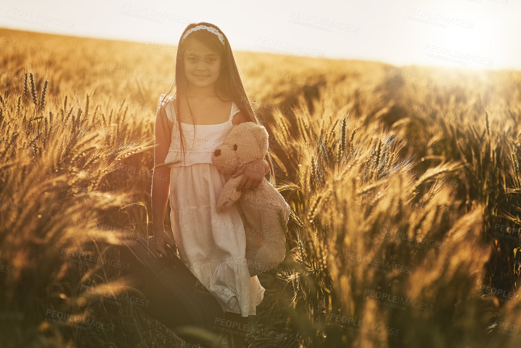 Buy stock photo Girl, portrait and teddy bear in nature for love, care and hug in corn field or countryside. Kid or child, embrace and toy for play in environment for holiday, growth and development or outdoor game