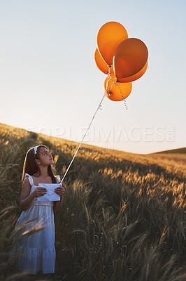 Buy stock photo Kid, letter and balloons outdoor in field for communication, wish and message to the sky for fantasy with mockup. Girl, child and paper in cornfield with travel, innocent and post with sunlight