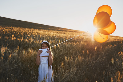 Buy stock photo Child, balloons and portrait in field outdoor for communication, letter and message to the sky for fantasy with mockup. Girl, kid and paper in cornfield with travel, innocent and post with sunlight