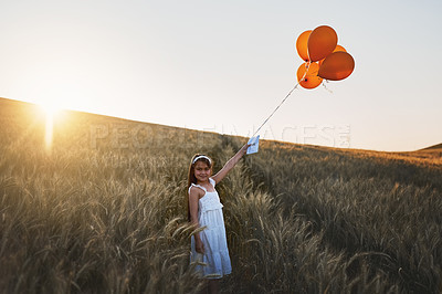 Buy stock photo Child, letter and balloons or happy in field for communication, wish and message to the sky for fantasy with portrait. Girl, kid and paper in cornfield with travel, innocent and smile with sunlight