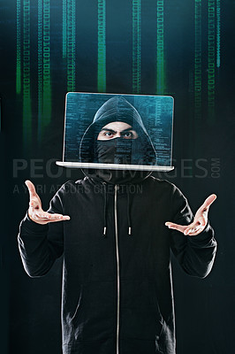 Buy stock photo Portrait of a computer hacker levitating a laptop while standing against a dark background