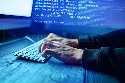 Buy stock photo Cropped shot of an unidentifiable hacker using a computer late at night
