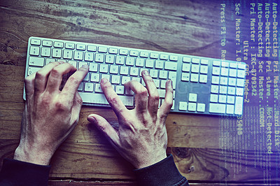 Buy stock photo Cropped shot of an unidentifiable hacker using a computer late at night