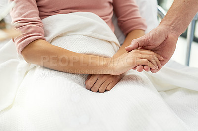 Buy stock photo Cropped shot of an unidentifiable doctor holding his patient's hand in the clinic