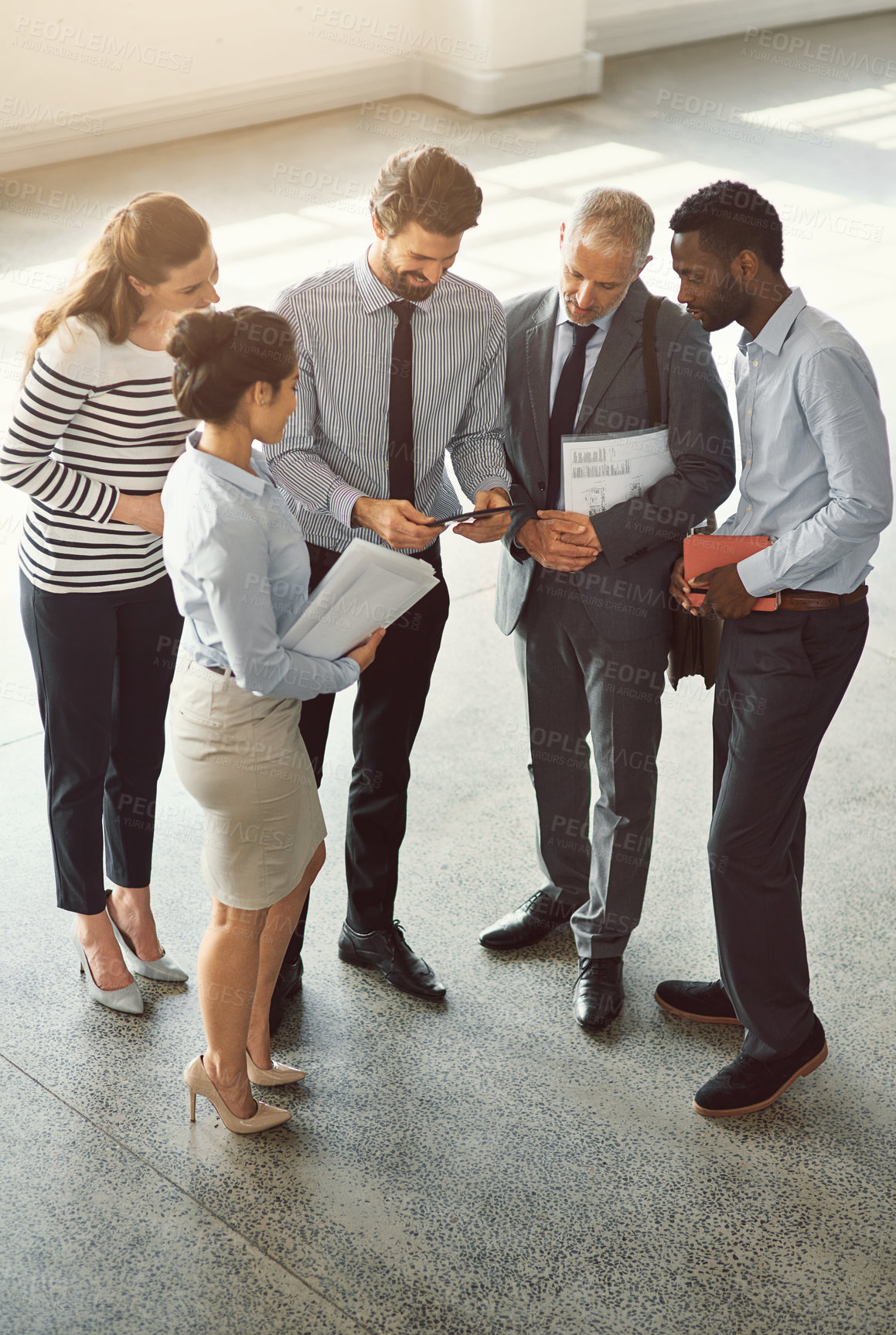 Buy stock photo Office building, above and business people with tablet in meeting for corporate, project and review. Finance, paperwork and employees with tech in lobby for investment, forecasting and market trends