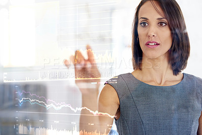 Buy stock photo Shot of a young businesswoman using a digital interface while standing in a modern office