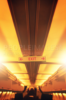 Buy stock photo Shot of an exit sign inside an airplane