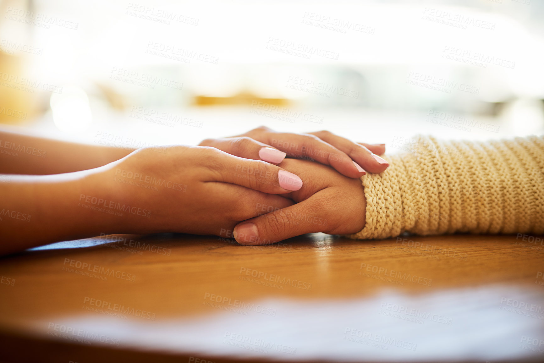 Buy stock photo Caring, closeup of women holding hands on table and for support or comfort. Cancer or compassion, gratitude or kindness and female friends touching helping hand together for love or empathy.