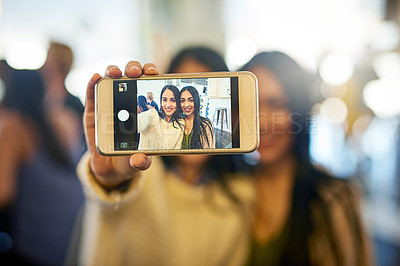 Buy stock photo Cropped shot of two young friends taking a selfie together