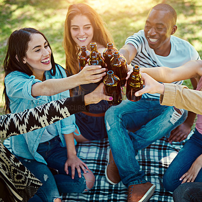 Buy stock photo Cropped shot of a group of friends having drinks while out on a picnic