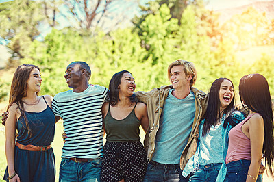 Buy stock photo Cropped shot of a group of young friends hanging out together at the park