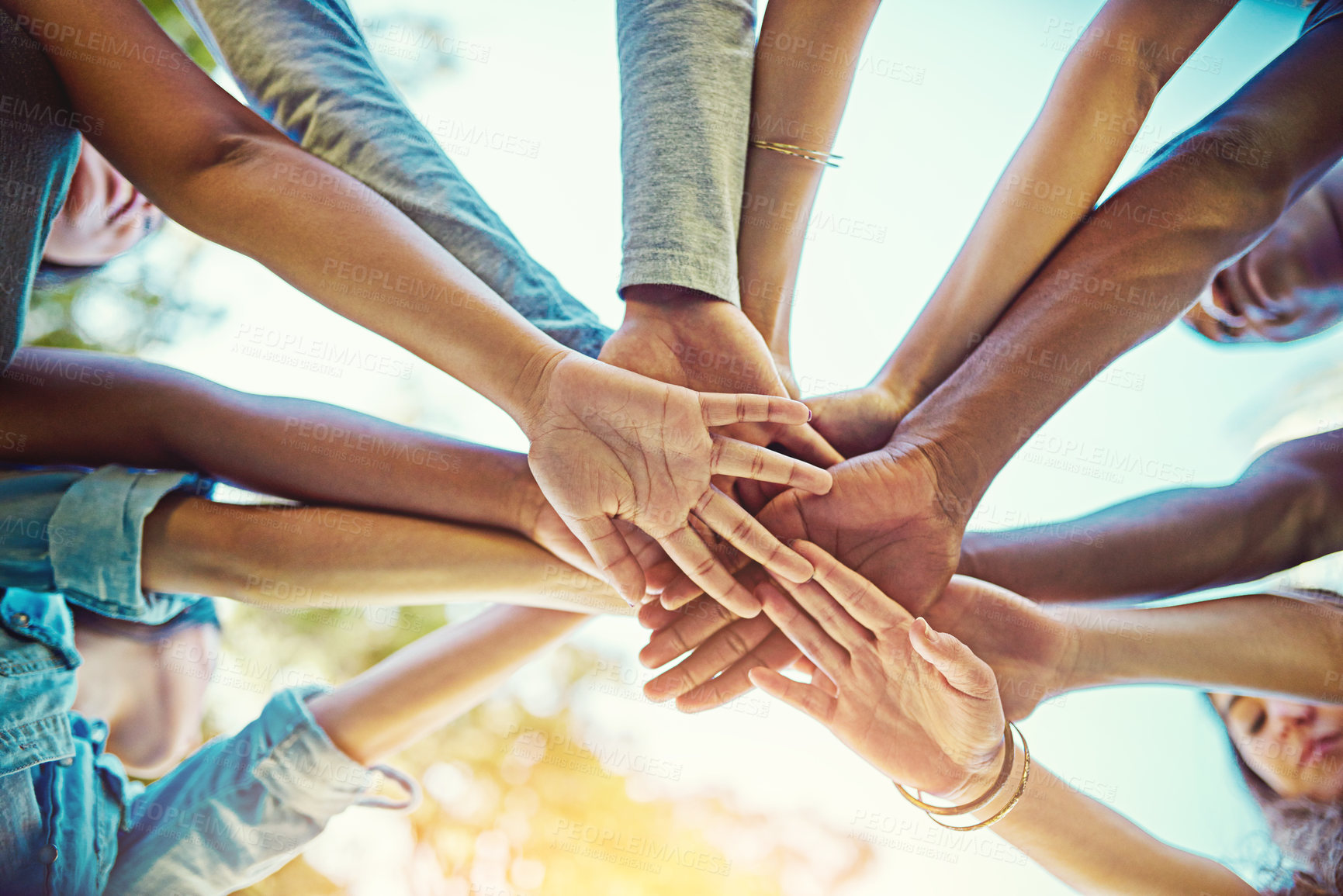 Buy stock photo Cropped shot of a group of friends with their hands piled on top of each other