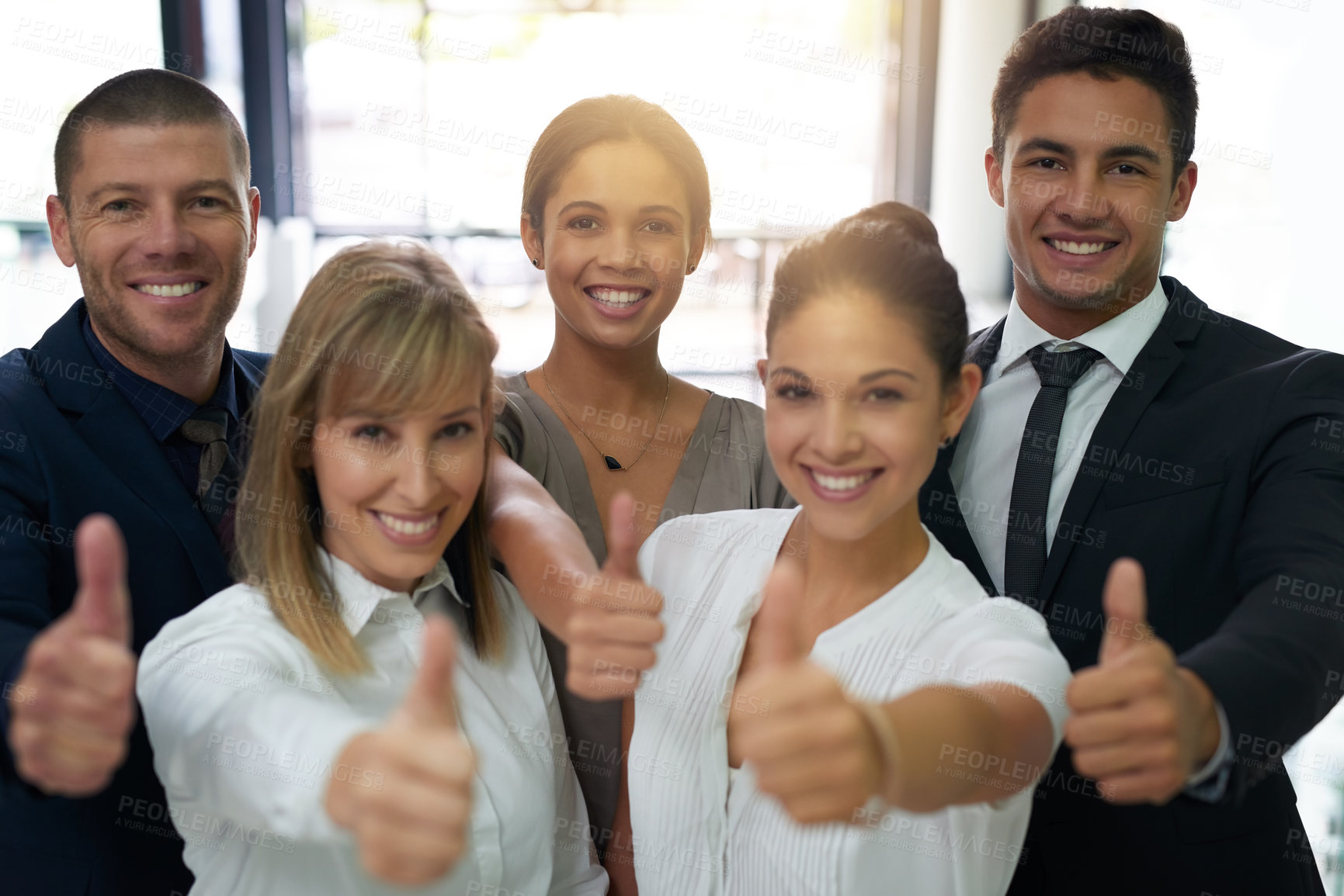 Buy stock photo Portrait of a group of businesspeople showing thumbs up in an office