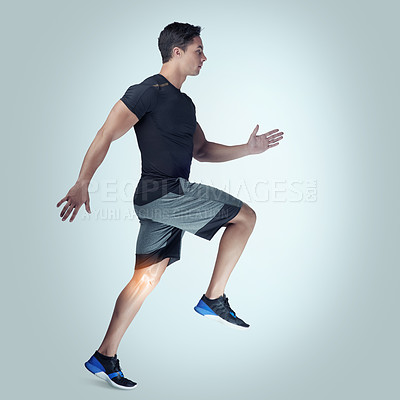 Buy stock photo Studio shot of an athletic young man running against a grey background