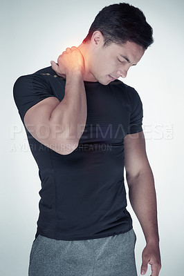 Buy stock photo Studio shot of an athletic young man suffering with neck pain against a grey background