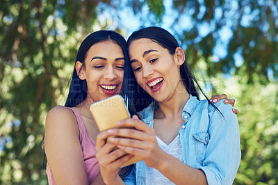 Buy stock photo Women, friends and phone in park with laugh for funny meme, video or notification on social media. Girl, students and smartphone for reading, happy and watch live stream for comic story on mobile app