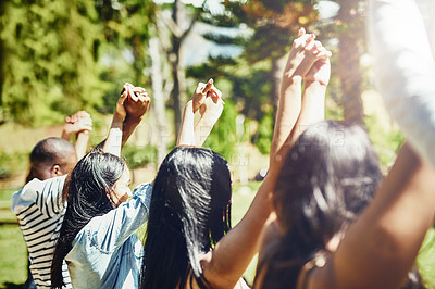 Buy stock photo Students, celebration and holding hands up at park with solidarity, link and connection for success at college. Women, men and friends with support, motivation and cheers with goals at university