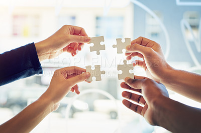 Buy stock photo Shot of a group of unidentifiable friends holding up puzzle pieces toegther