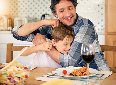 Buy stock photo Shot of a father bonding with his little son at home