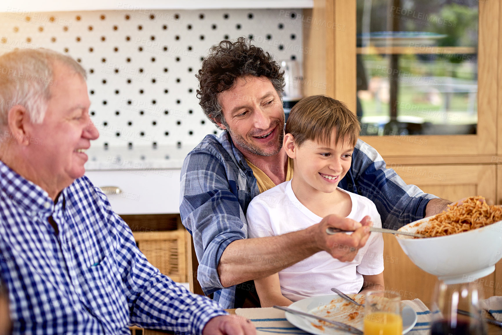 Buy stock photo Father, grandfather and child eating lunch in home for healthy diet, nutrition or wellness. Dad, hungry kid and serve food or spaghetti to happy boy bonding with senior grandpa, family or generations