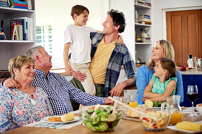 Buy stock photo Shot of a multi generational family enjoying a meal together at home