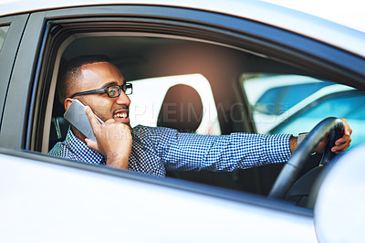 Buy stock photo Cropped shot of a young businessman talking on a cellphone while driving a car