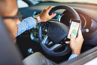 Buy stock photo Cropped shot of a man using his phone while driving