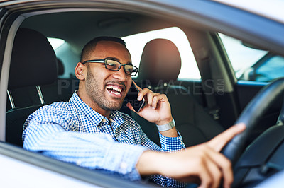 Buy stock photo Cropped shot of a young businessman talking on a cellphone while driving a car