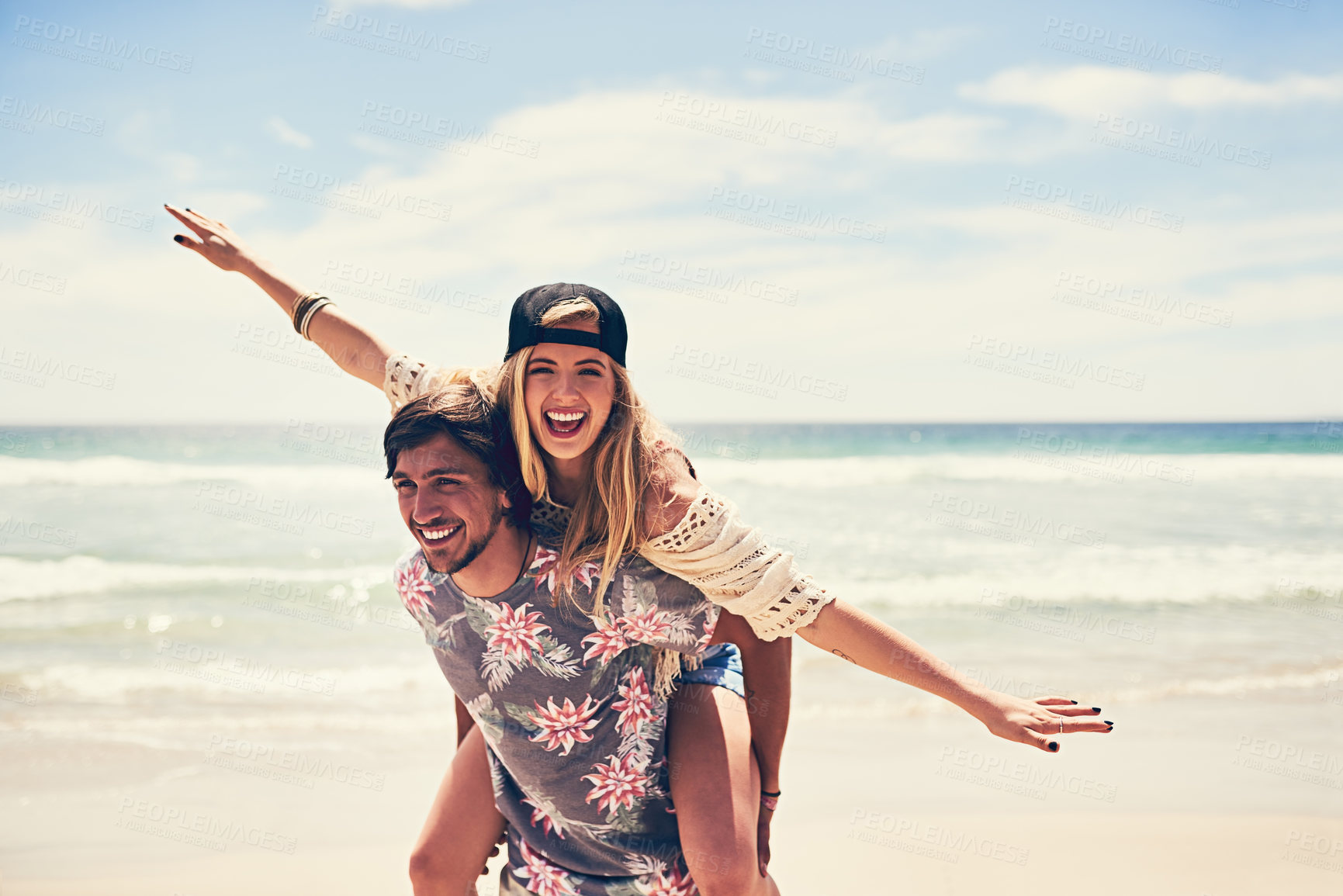 Buy stock photo Happy couple, beach and piggyback on holiday for travel in Puerto Rico, smile for freedom in nature. Wellness, adventure and man with support for woman by ocean, together on island vacation by sea